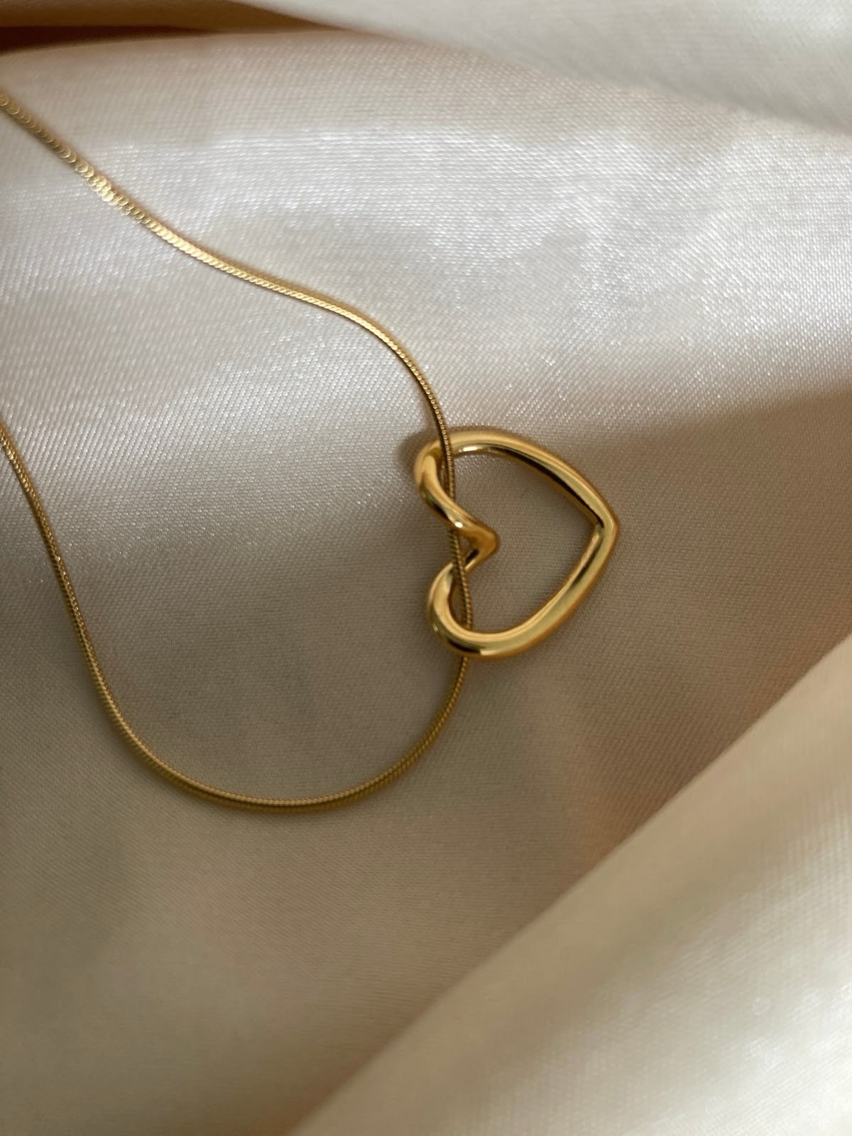 Golden heart knot necklace